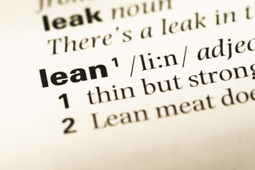 Fototapeta premium Close up of old English dictionary page with word lean