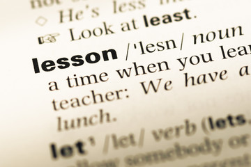 Fototapeta premium Close up of old English dictionary page with word lesson
