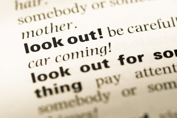 Obraz premium Close up of old English dictionary page with word look out