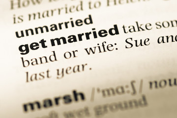 Close up of old English dictionary page with word get married