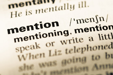 Obraz premium Close up of old English dictionary page with word mention