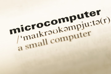 Fototapeta premium Close up of old English dictionary page with word microcomputer
