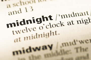 Close up of old English dictionary page with word midnight