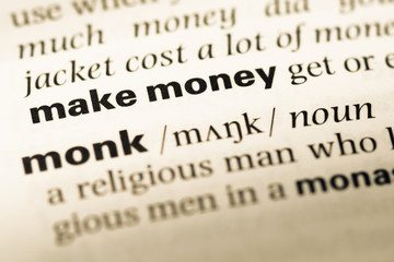 Obraz premium Close up of old English dictionary page with word make money