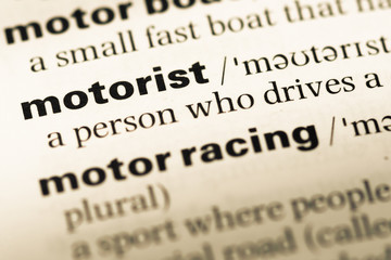 Obraz premium Close up of old English dictionary page with word motorist