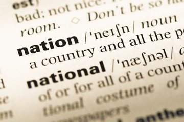 Close up of old English dictionary page with word nation