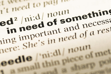 Fototapeta premium Close up of old English dictionary page with word in need of
