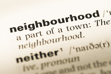 Close up of old English dictionary page with word neighbourhood