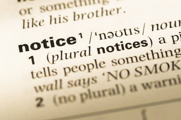 Obraz premium Close up of old English dictionary page with word notice