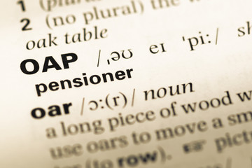 Fototapeta premium Close up of old English dictionary page with word OAP