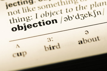 Close up of old English dictionary page with word objection © TungCheung