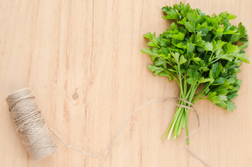 Organic fresh bunch of parsley on a wooden rustic table