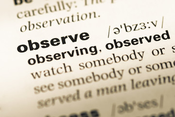 Close up of old English dictionary page with word observe