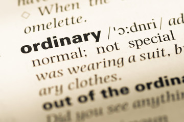 Close up of old English dictionary page with word ordinary