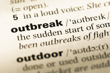 Obraz premium Close up of old English dictionary page with word outbreak