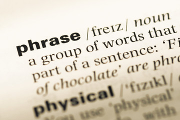 Close up of old English dictionary page with word phrase