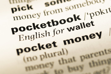 Obraz premium Close up of old English dictionary page with word pocketbook