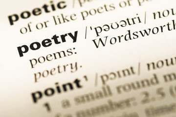 Close up of old English dictionary page with word poetry