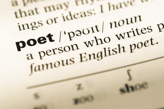 Close up of old English dictionary page with word poet