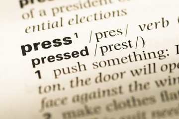 Fototapeta premium Close up of old English dictionary page with word press