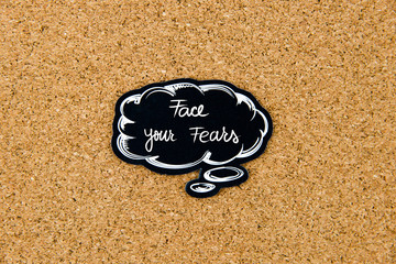 Face Your Fears written on black thinking bubble