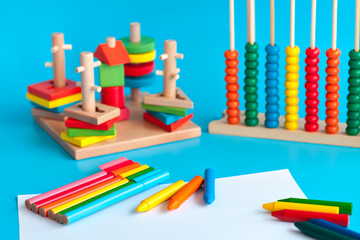 Naklejka premium Colorful wooden toy building blocks toys on blue