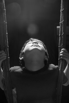 Little Boy Playing Swing Indoor Rim Light Black And White