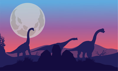 Brachiosaurus of silhouette with moon