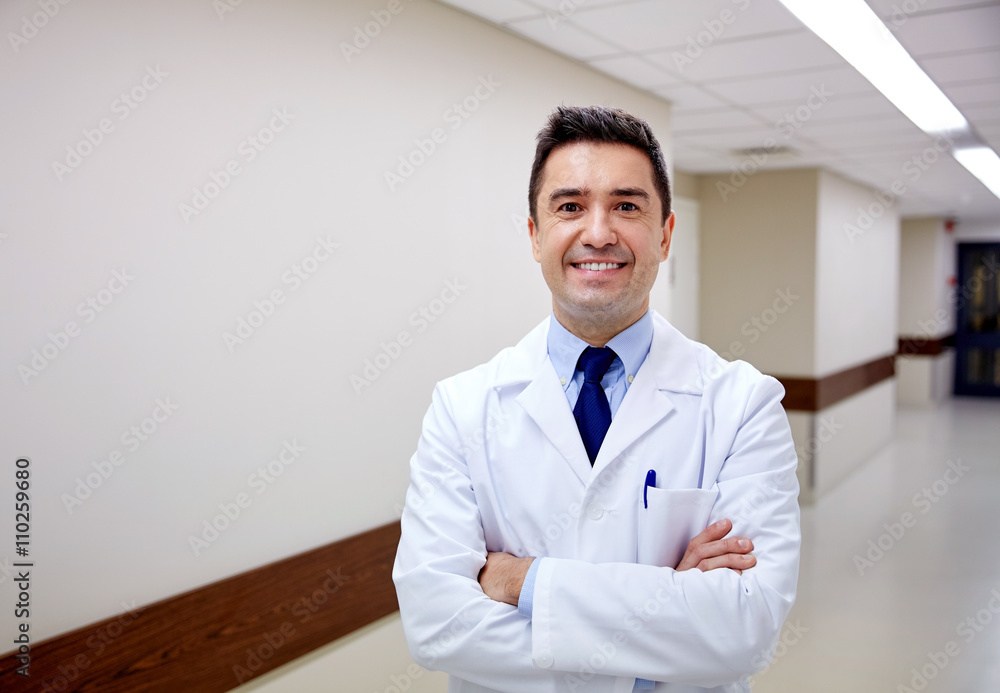 Poster smiling doctor at hospital corridor