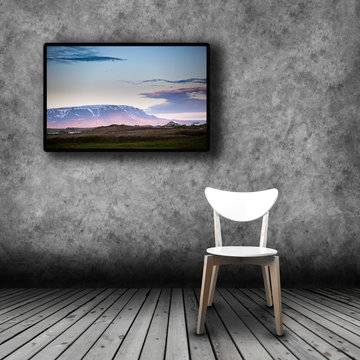 Plasma TV on the wall of the room with empty chair