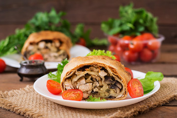 Homemade strudel with chicken, mushrooms, cheese and parsley