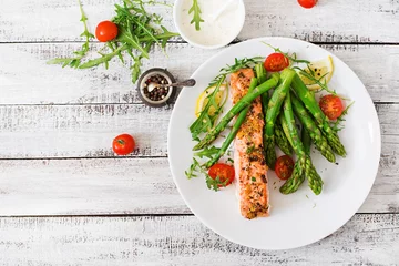 Outdoor kussens Baked salmon garnished with asparagus and tomatoes with herbs. Top view © timolina