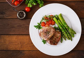 Fotobehang Gerechten Barbecue grilled beef steak meat with asparagus and tomatoes. Top view