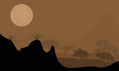 Silhouette of triceratops with moon at night