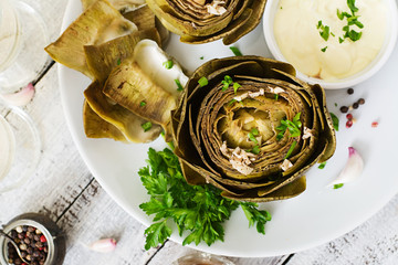 Baked artichokes cooked with garlic sauce, mustard and parsley. Top view