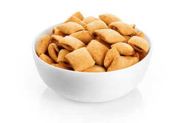 Bowl with corn pads isolated on white background. Cereals.