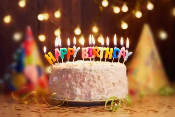Fotobehang Birthday cake with candles, bright lights bokeh. © Studio Romantic
