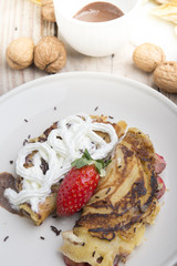 delicious crepes with berries and chocolate sauce, closeup