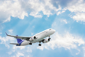 Fototapeta na wymiar Airplane flying on blurred blue sky