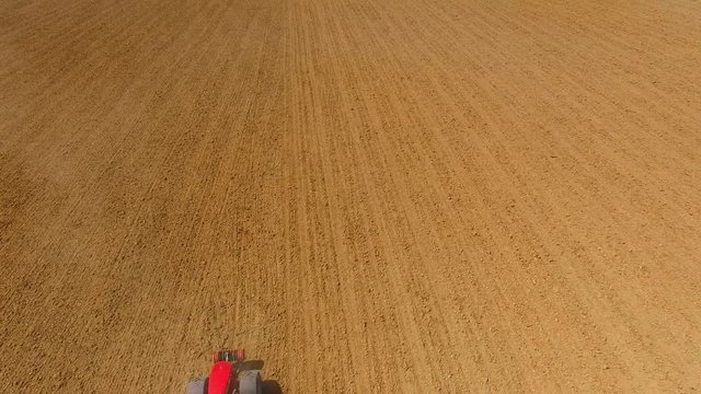 Aerial view of ploughed field with tractor. Industry and Agriculture in Czech Republic, European Union.