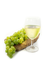 Green Grapes on Wood Plate with White Wine Glass Isolated, white background