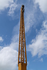 Fototapeta na wymiar The Yellow Vertical Lifting Jib of a Mobile Crane.