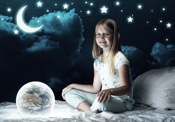 Naklejka premium Girl in her bed and glowing globe