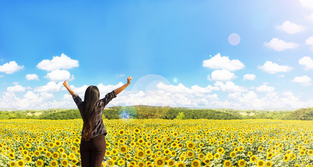 Rare view of women raise arms embrace sunflowers field 