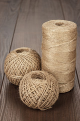 reel and balls of durable thread on the wooden table