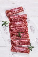 Delicious salami with basil and wine, selective focus