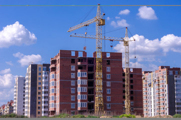 Construction of a brick high-rise building with a crane