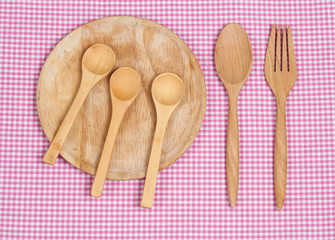 Color tablecloth, spoon, fork on  table background