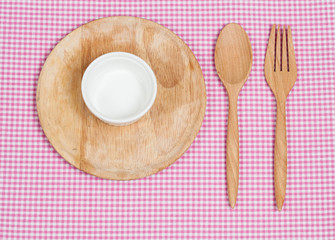 Color tablecloth, spoon, fork on  table background
