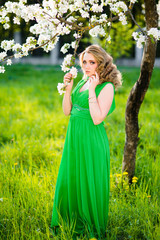 Fototapeta premium fashion beautiful blonde woman in blossoming garden of Apple trees